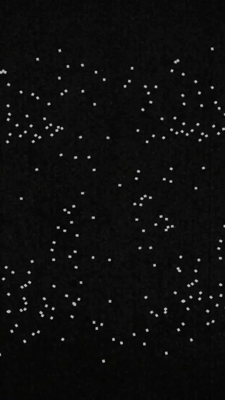 Animation of glowing light spots moving over black background
