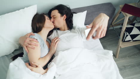 Couple Taking Selfie in Bed