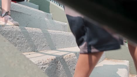 close up shot of shoes walking down the stairs on concrete steps