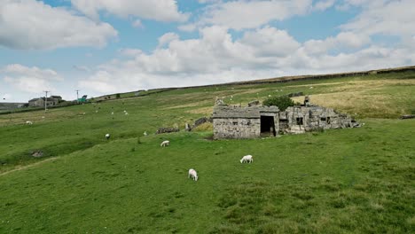 aerial footage of a old abandoned farm building on the west yorkshire moors above halifax