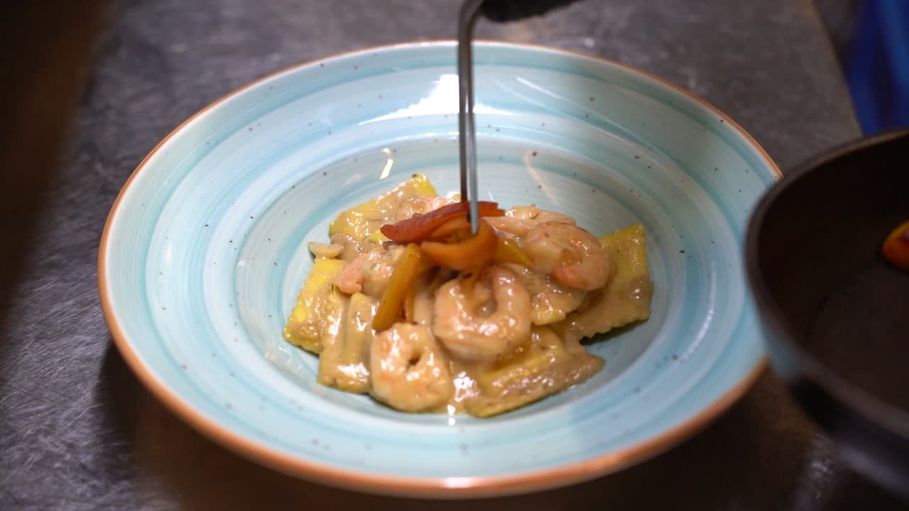 Plate of ravioli with shrimp in sour cream