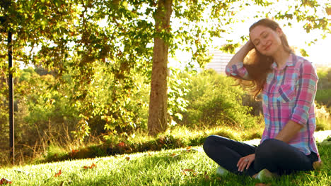 Woman-Sitting-and-Smiling-at-Peace-With-Life-at-Park