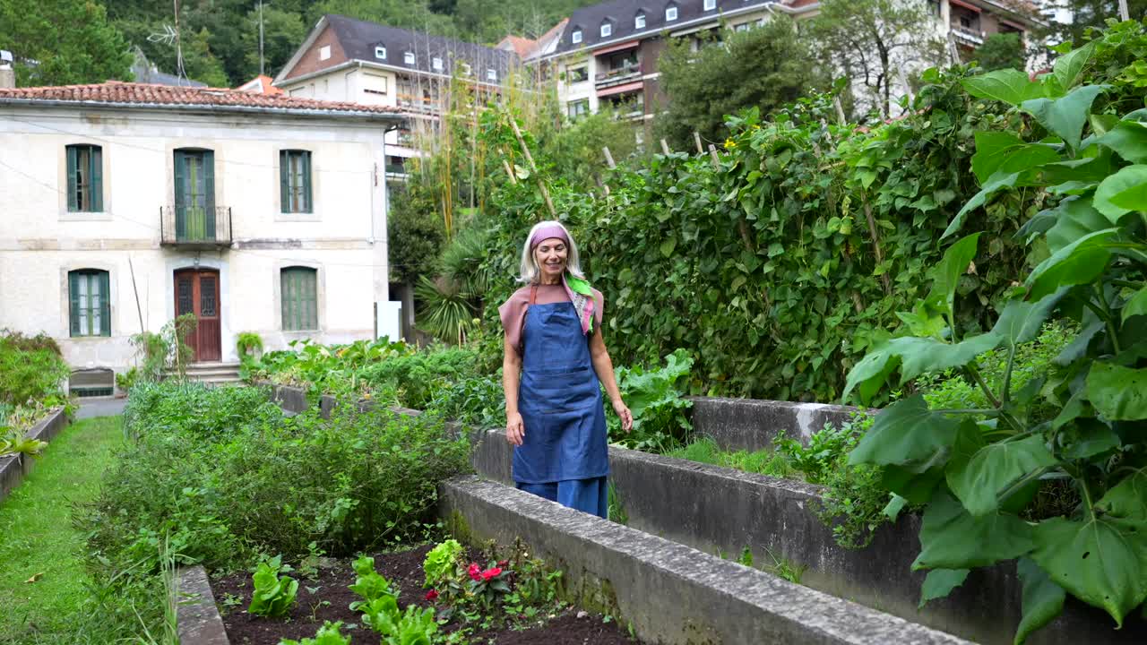 A woman tending to a vegetable garden