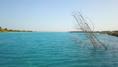 Drone-flying-low-over-Toxic-Siberian-lake,-Novosibirsk-Maldives,Russia