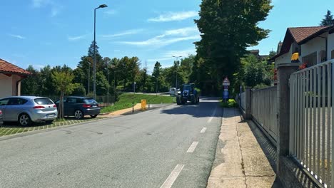 tractor moves along a quiet italian street