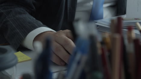 hand of a man working on a computer in office