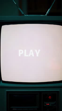 retro television with 'play' displaying glitch art and static