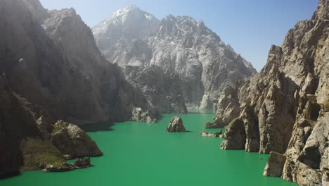 epic cinematic drone shot going through the rocky ravine in the kel-suu lake in kyrgyzstan