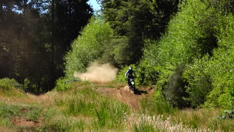 motorcycle jump on motocross track in el bolson, argentina, static wide shot