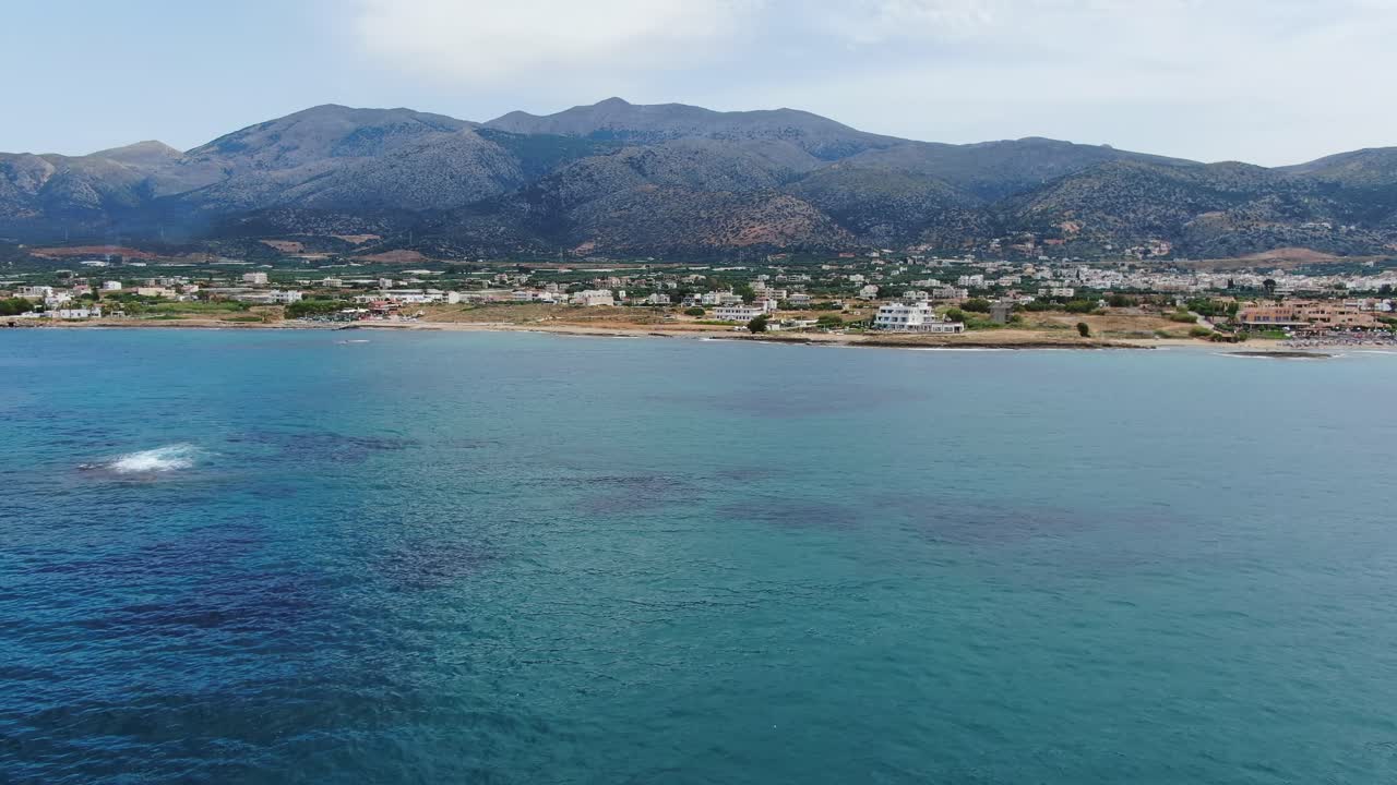 Turquoise water, golden sand beach and mountains in Crete island. Aerial view