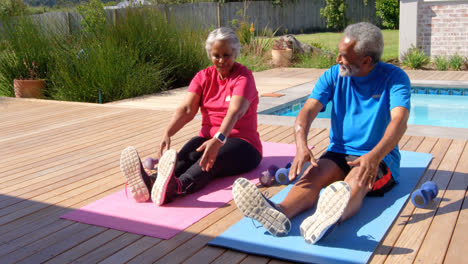 front view of old asian senior couple exercising in the backyard of their home 4k