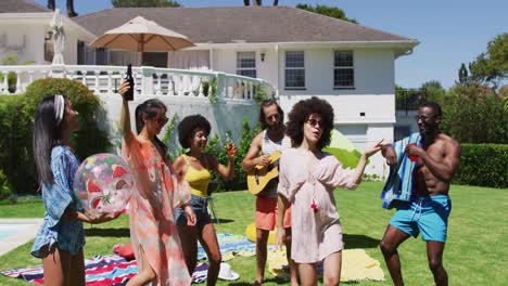 diverse group of friends having fun and dancing at a pool party