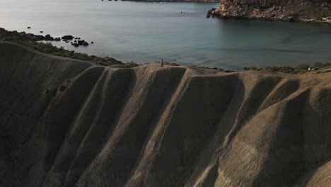 Drone-footage-of-Fashion-Model-standing-on-the-mountain