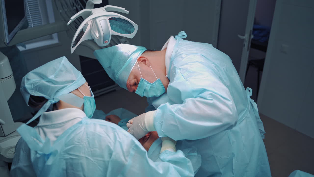 Dentists working with client teeth. Modern stomatology private clinic with professional equipment