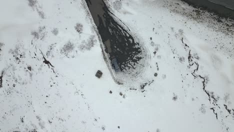 Aerial-view-spinning-while-going-up-into-the-sky-looking-down-on-a-car-in-Iceland