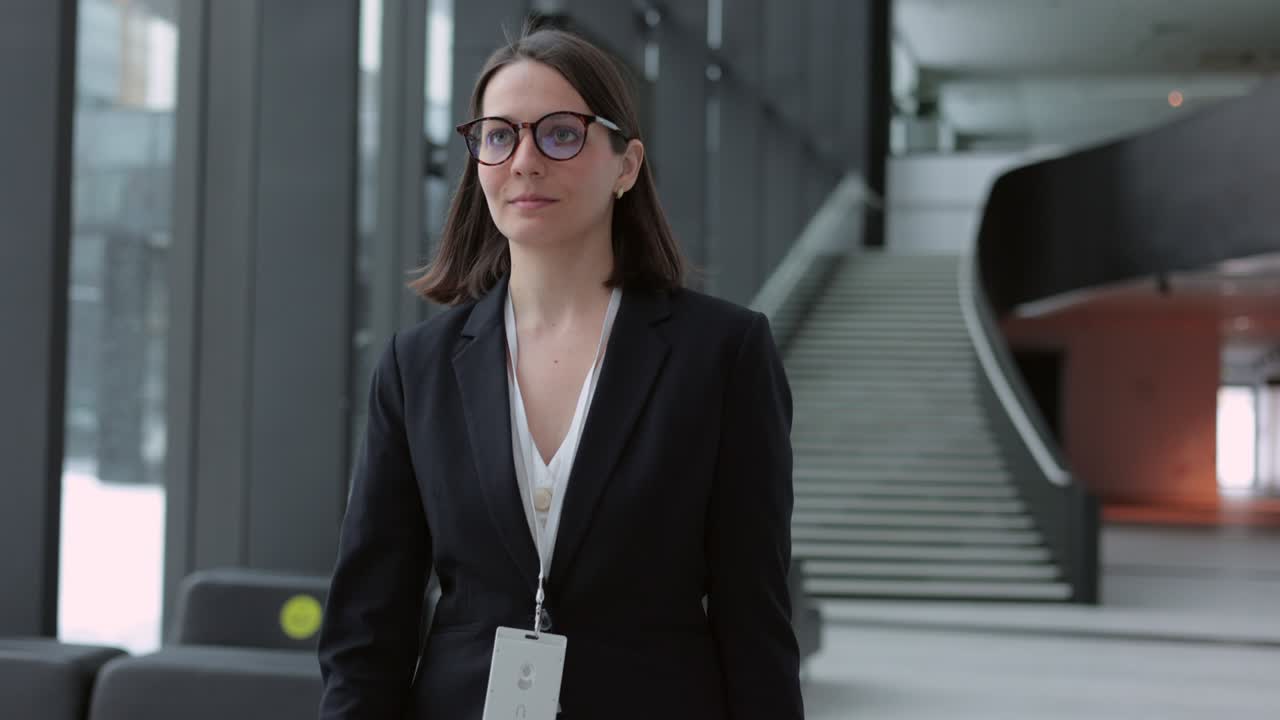 business woman in a business suit with a suitcase walks through the airport or business center and talks on the phone. a European confident woman