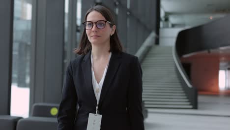 business woman in a business suit with a suitcase walks through the airport or business center and talks on the phone. a european confident woman