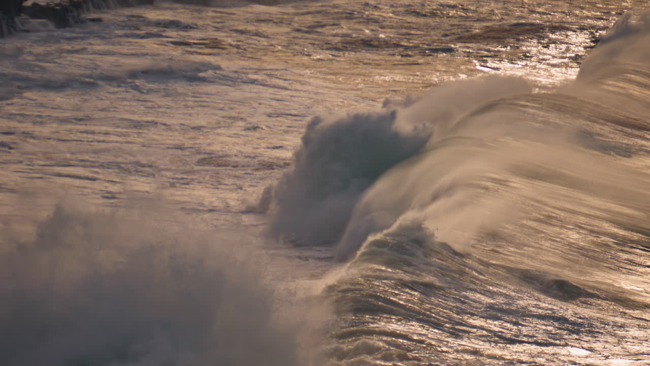 Dramatic ocean rolling shallow reef in morning. Powerful waves breaking rocky