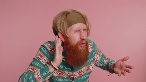 man with a red beard listening intently