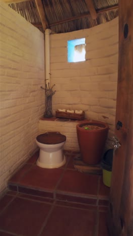 vertical view of a dry bathroom design inside a cob house. pov shot