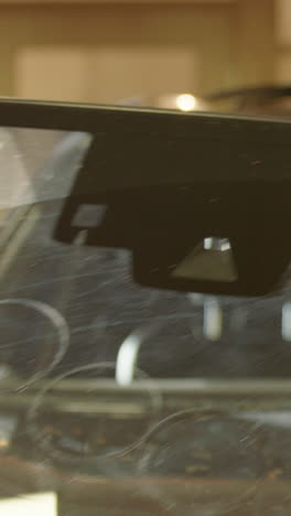 suction cups with handles used to lift cracked windshield free of car, vertical