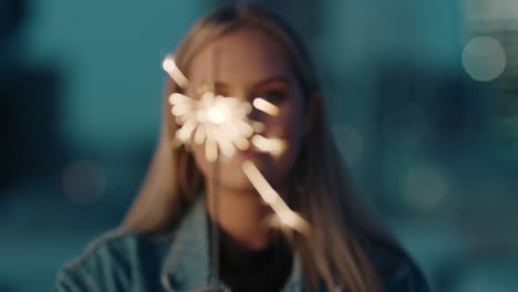 close-up-sparkler-beauitful-caucasian-woman-celebrating-new-years-eve-rooftop-party-at-sunset