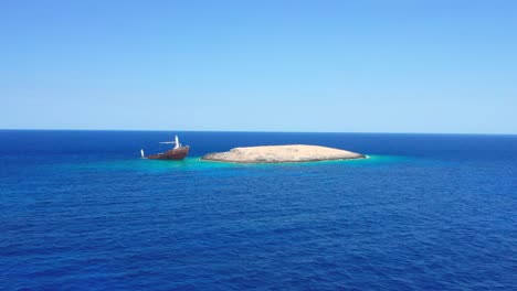 Panoramic-wide-shot-of-Nordland-shipwreck-in-intense-blue-sea