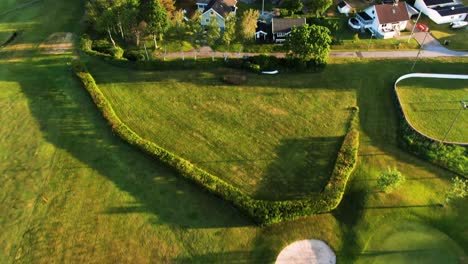 aerial tilt down backward over empty golf course, hills golf club in molndal near gothenburg