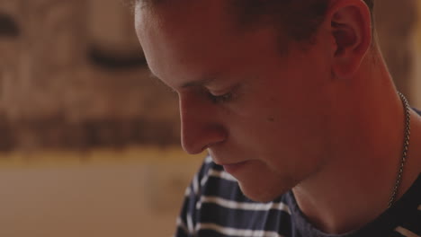 Face-of-focused-young-caucasian-man-in-navy-blue-striped-T-shirt