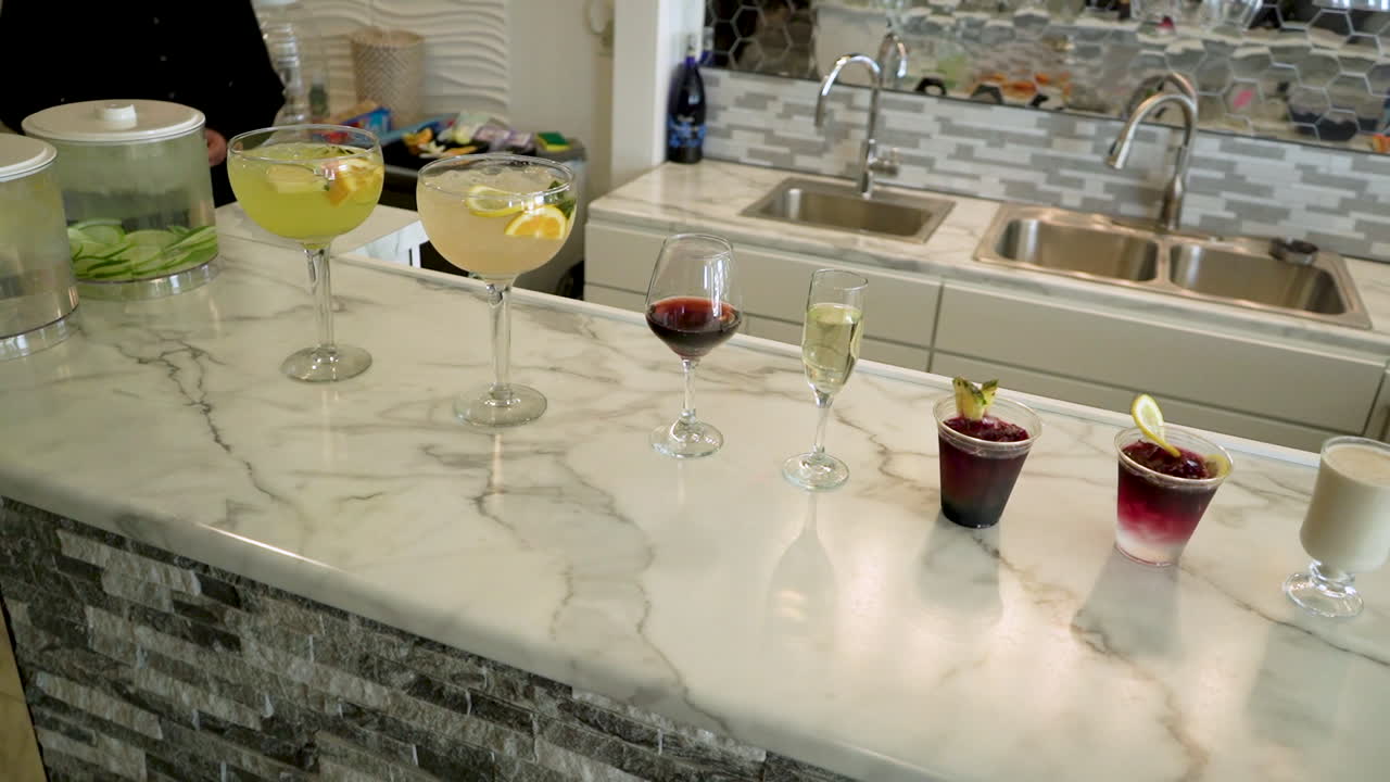 row of mixed drinks at a salon bar