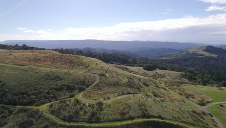 drone jibing up across rolling northern california hills during golden hour