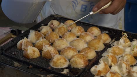 thailand night market street food booth cooking squid octopus cuttlefish ball