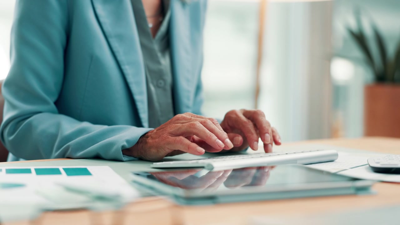 Professional Woman Typing on Keyboard at Office Desk