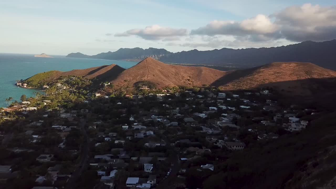 Aerial View of Coastal Community and Mountains