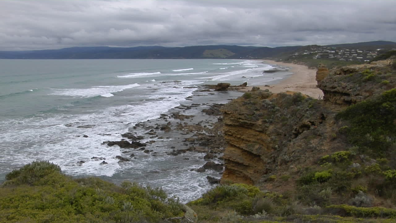 Waves Roll Onto The Rugged Coastline Of South Victoria Australia