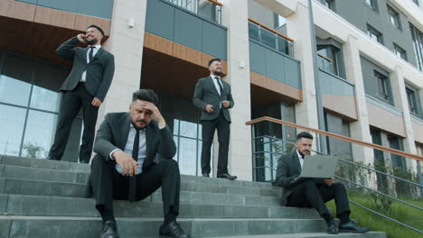 businessmen on stairs displaying various emotions