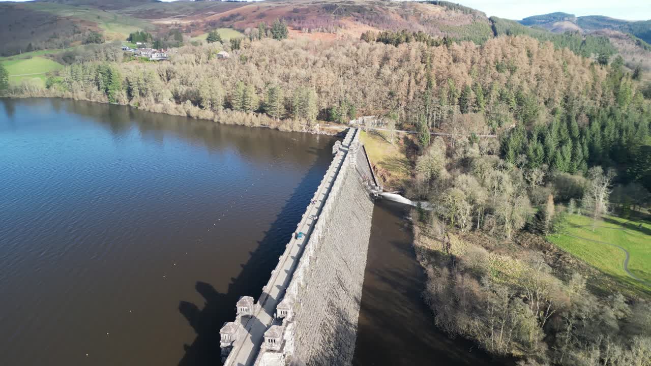 Lake Vyrnwy dam drone anti-clockwise rotate revealing beautiful lake on a crisp, calm, sunny winter afternoon - Wales, UK