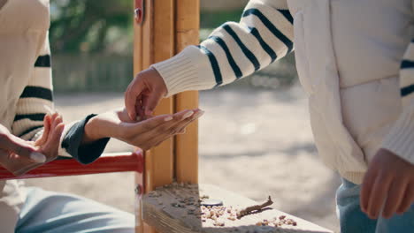 unrecognizable child playing with mom on playground close up. girl enjoying game