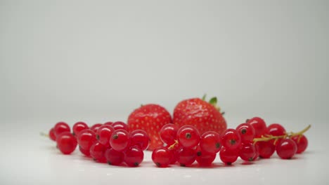 beautiful red strawberries and cherries in pure white background - close up shot