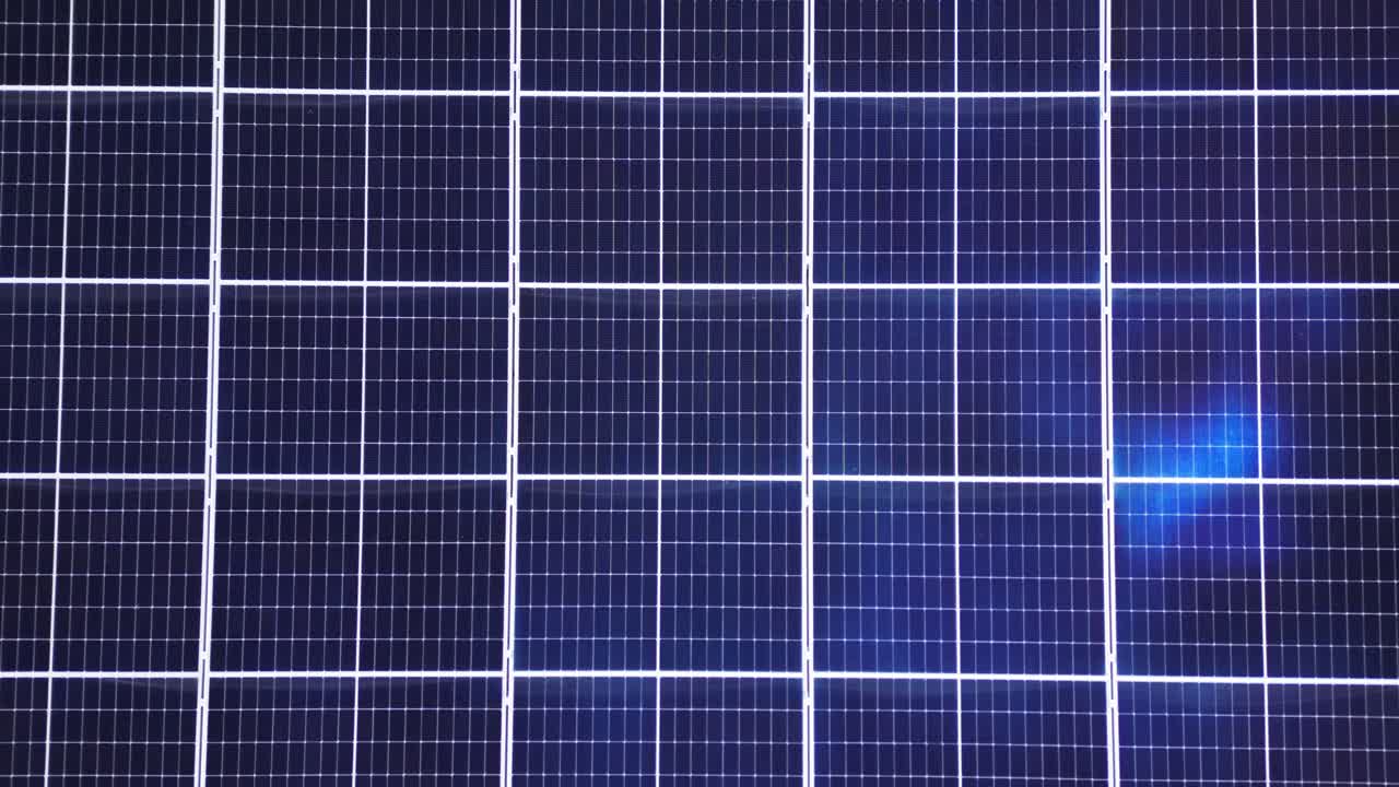 Symmetrical aerial view of solar panel array with visible air conditioning units on white rooftop. Shot at Riva di Solto, Bergamo, Italy