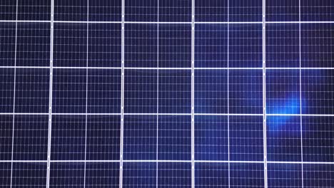 symmetrical aerial view of solar panel array with visible air conditioning units on white rooftop. shot at riva di solto, bergamo, italy