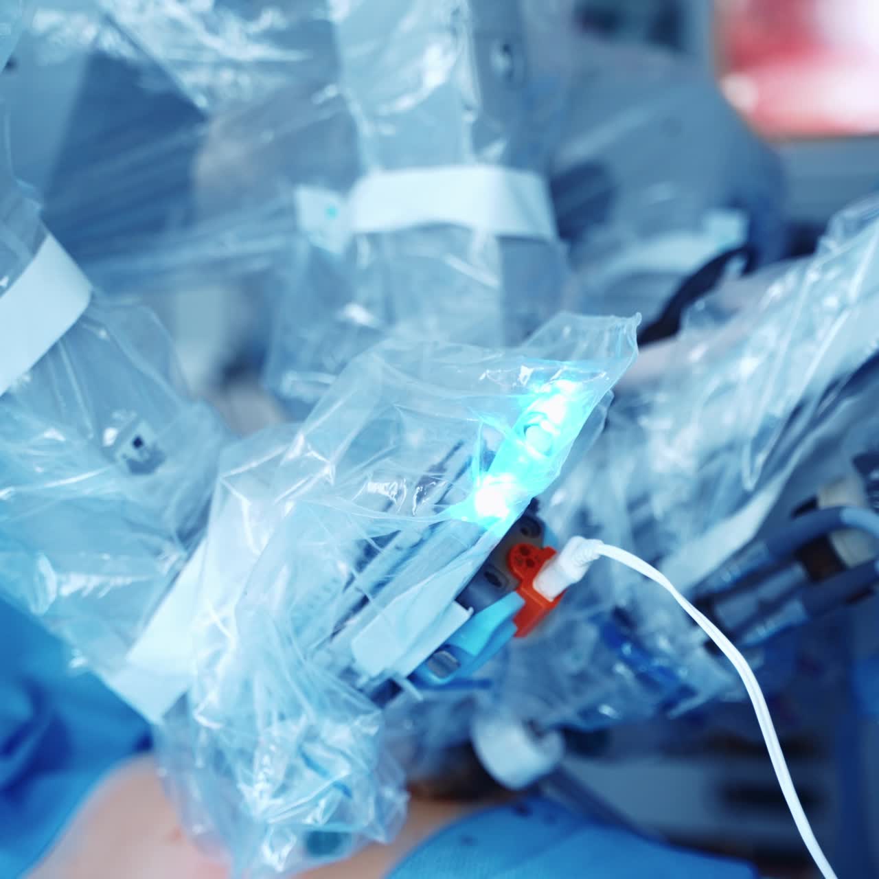 Futuristic robot perform a surgery. Robotic equipment during difficult operation to a patient. Minimally invasive surgery. New technologies in medicine.