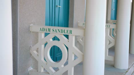 beach huts with the name of famous hollywood actor at promenade des planches at deauville, normandy, france