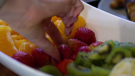 Close-up-shot-of-women-picking-up-strawberries