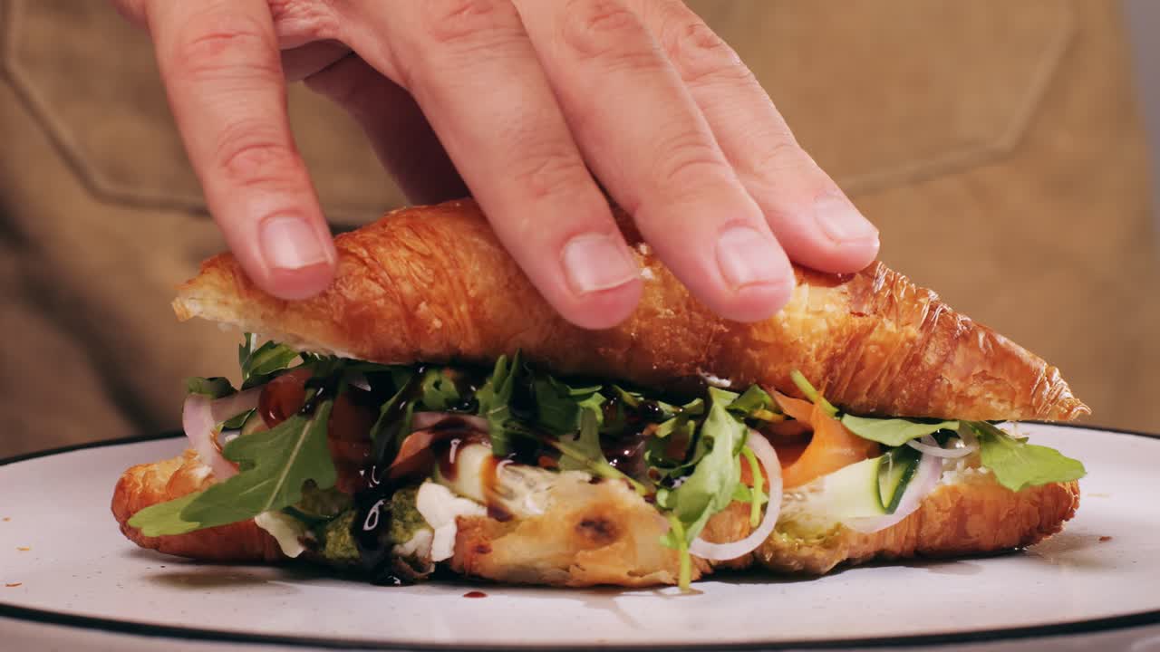 Croissant with jamon ham, Salmon, in Modern Cafe, Top View of Healthy Breakfast in Cafe. English breakfast: fried egg, bacon toast on sandwich.