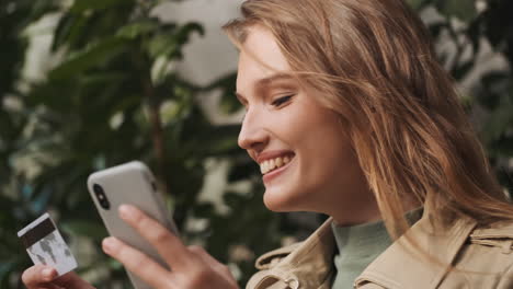 caucasian female student online shopping on smartphone outdoors.