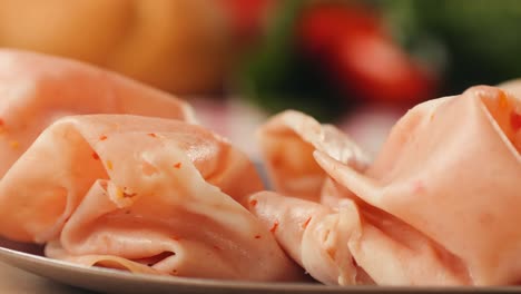 ham italian mordatella, man slices of traditional italian antipasti mortadella sausage on a wooden cutting board, close up macro of chicken or turkey jamon, fat breakfast dish.