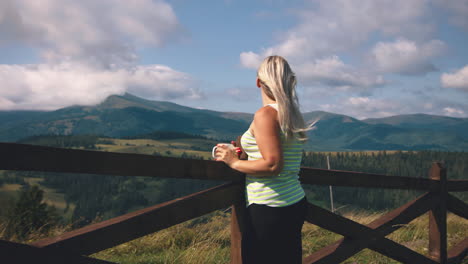 woman enjoying a coffee in the mountains