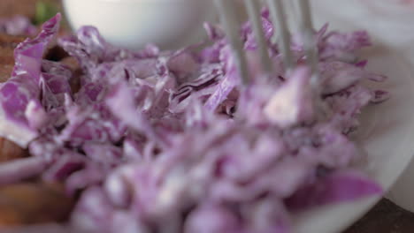 eating sausages and red cabbage salad