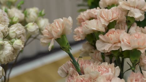 Pink-carnations-and-white-roses-in-vases-at-a-florist's-studio-shop